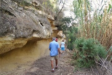 Walking along jagged sand rocks - Van Dam Estates